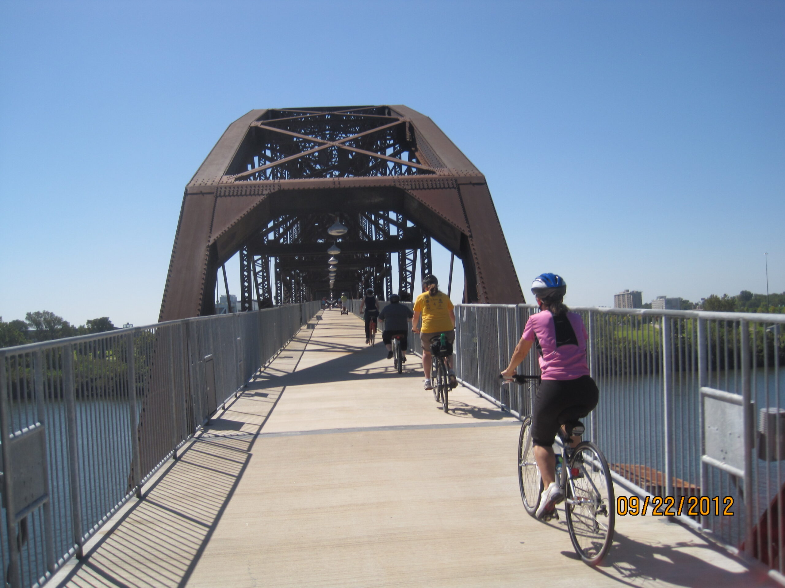 Cyclists riding over Clinton Bridge