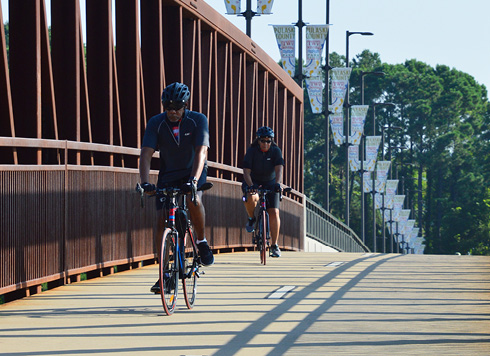 Bicyclists on the Two Rivers Park Bridge.
